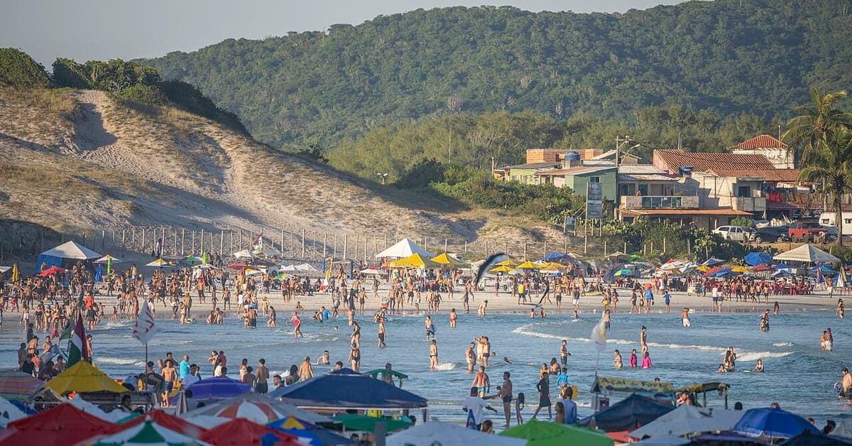 A crowded beach with umbrellas at Praia do Forte
