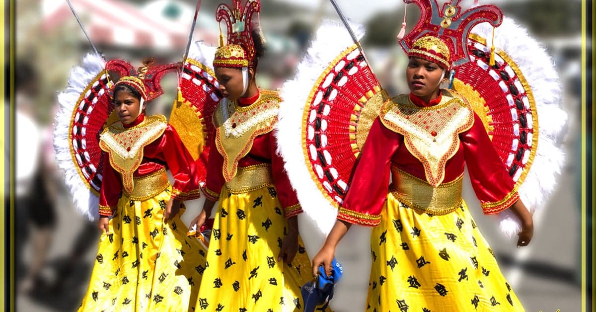 Carnival dancers in red and yellow costumes in Trinidad