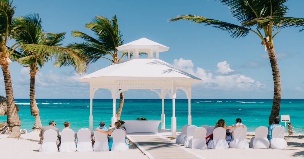 A couple posing for wedding photos on the white-sand beaches of Punta Cana, Dominican Republic