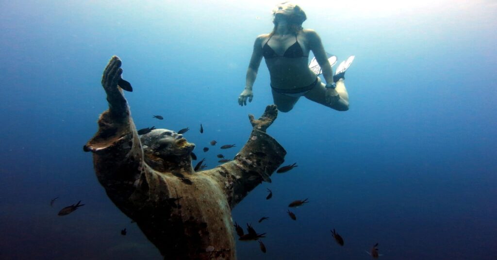 Scuba divers exploring a vibrant coral reef during a beach holiday excursion