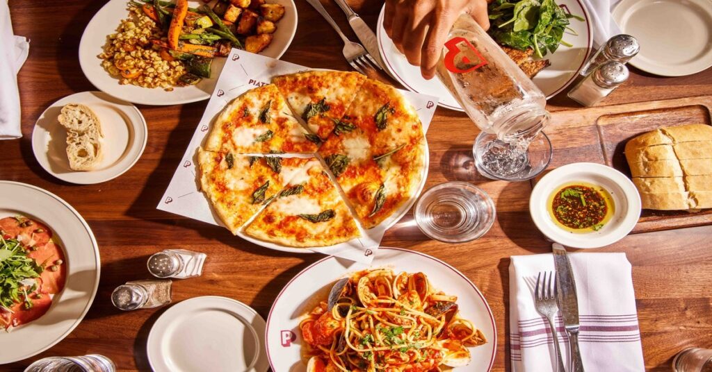 A spread of fresh Italian dishes including pasta, seafood, and local produce