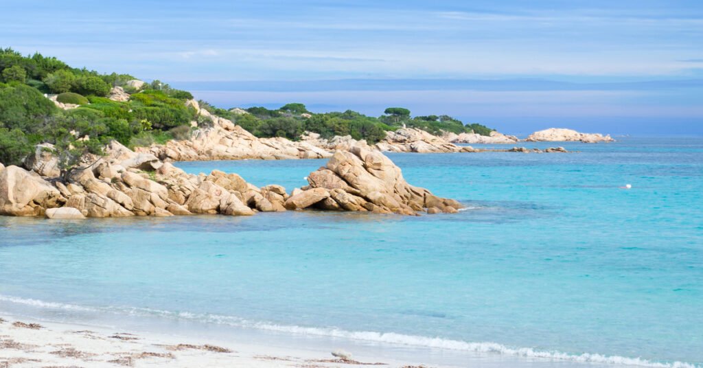 The emerald-green waters and white sandy beach of Costa Smeralda in Sardinia