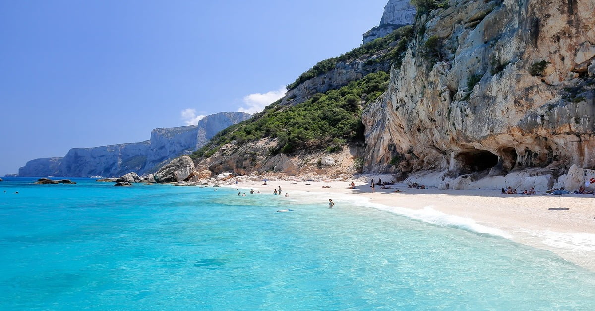 Cala Goloritzé beach on Sardinia's east coast with dramatic limestone cliffs and the Aguglia rock spire
