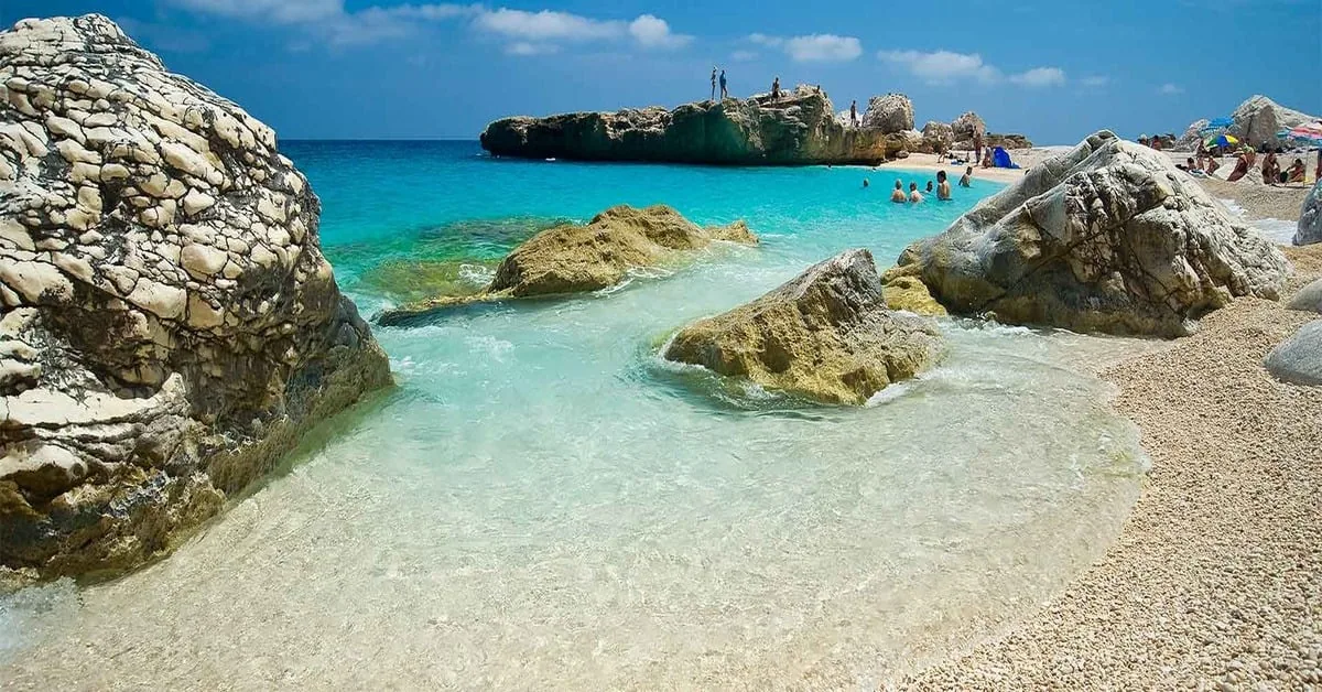 Cala Mariolu, a secluded beach in Sardinia accessible only by boat, with distinctive pink and white pebbles