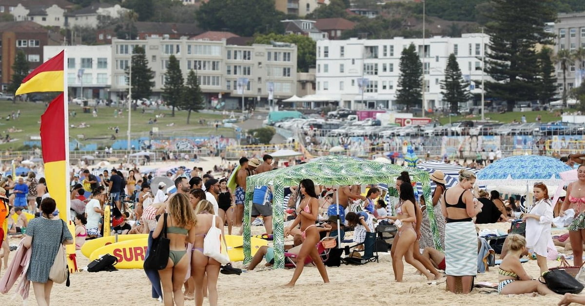 Bondi Beach in Sydney, Australia with surfers and golden sand