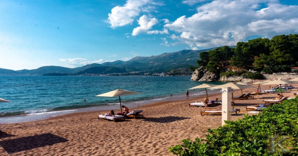 Porthcurno beach in England with dramatic cliff surroundings