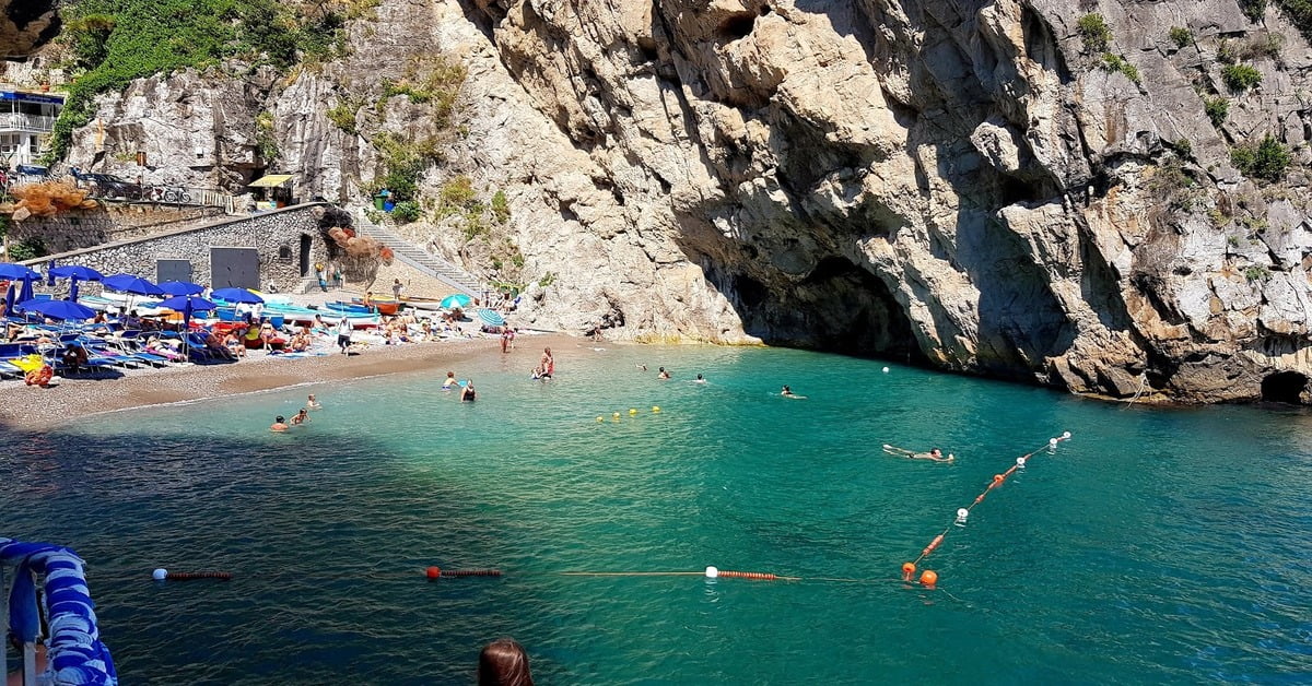 Marina di Praia beach in Praiano, nestled between dramatic cliffs with clear water ideal for kayaking and diving