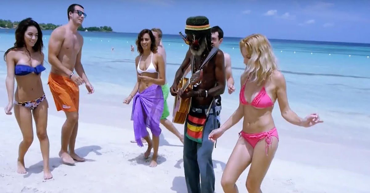 Seven Mile Beach in Negril, Jamaica with calm waters and lush tropical greenery