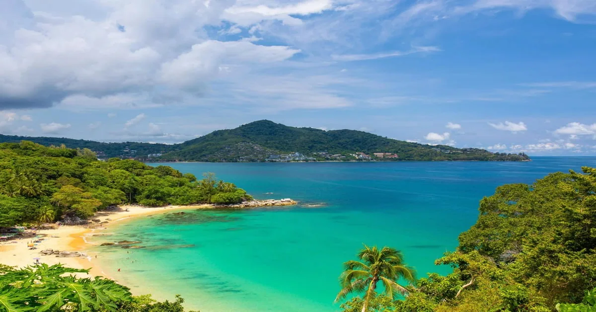 Bustling Patong Beach in Phuket, Thailand with colorful umbrellas and clear water