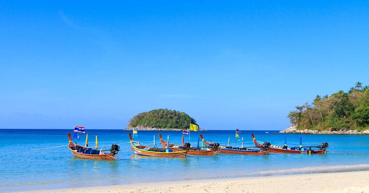 Scenic Kata Beach in Phuket with palm trees and gentle waves