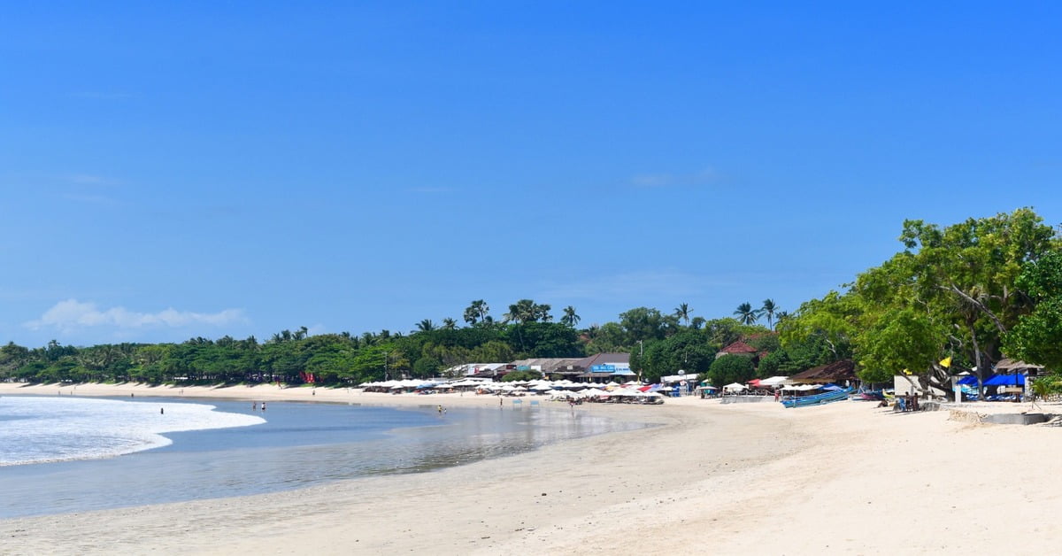 Traditional seafood dinner setup on Jimbaran Bay beach at sunset in Bali