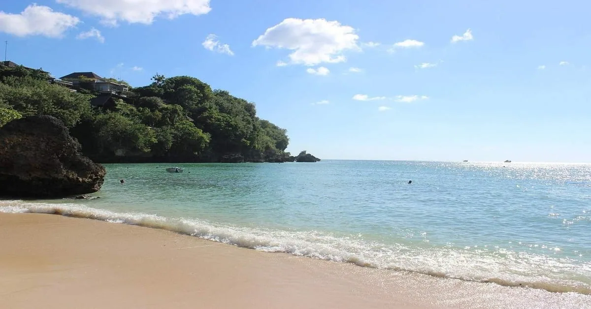 Hidden Padang Padang Beach in Bali accessed through a rocky cave entrance