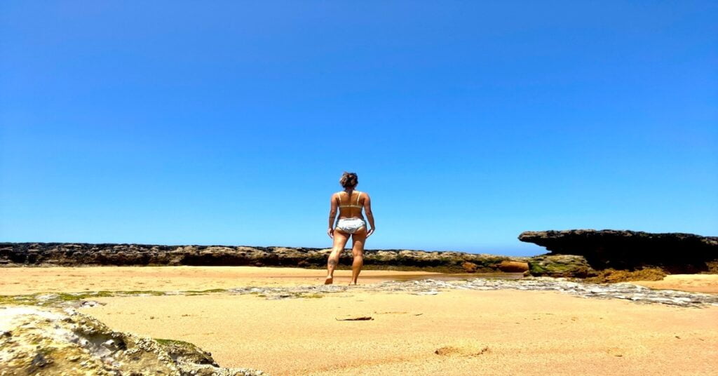 Rugged coastal scenery at Praia do Magoito with stratified rock formations