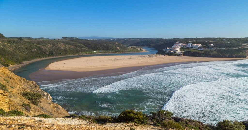 River meeting the ocean at Praia de Odeceixe in the Alentejo region of Portugal