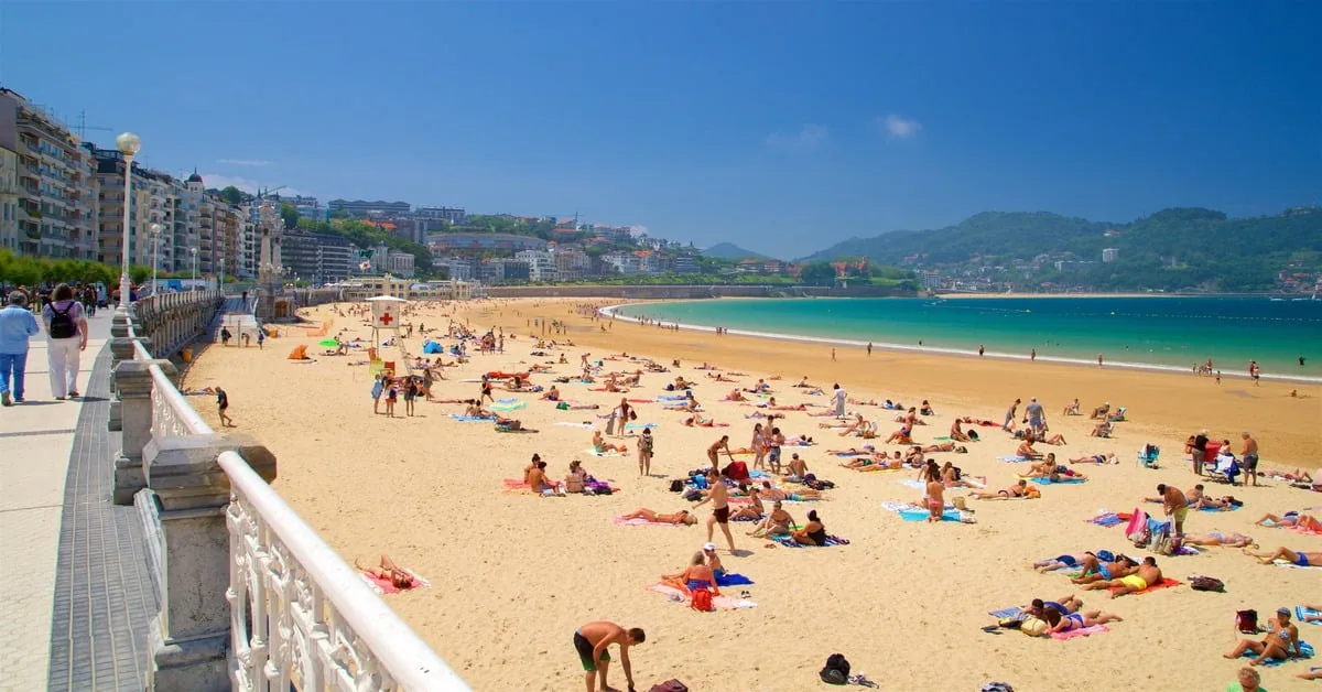 Sweeping crescent of La Concha Beach in San Sebastian, Spain with elegant promenade