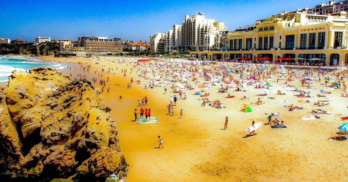 Surfers and dramatic coastline at Biarritz beach in southwestern France