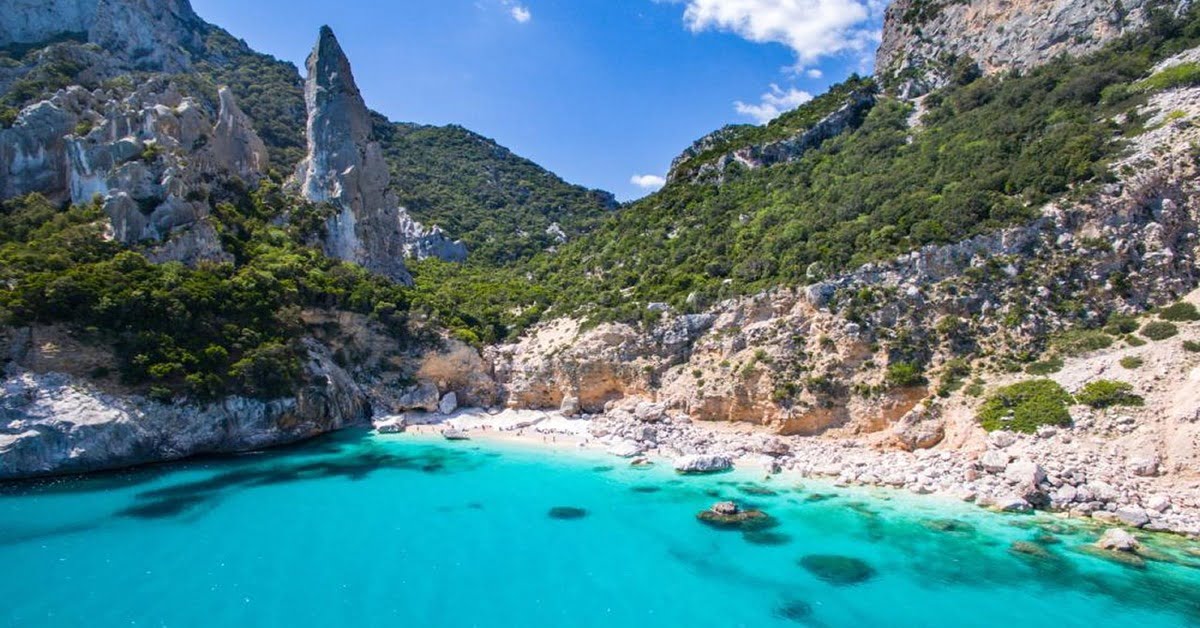 Towering limestone pinnacle and crystal water at Cala Goloritze in Sardinia, Italy