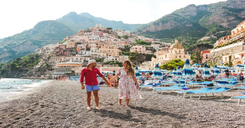 Positano's iconic beach with colorful buildings cascading down the hillside