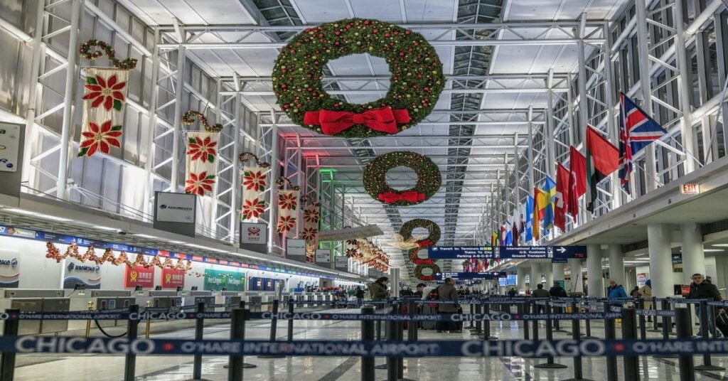 Busy airport terminal decorated for the holidays during peak travel season