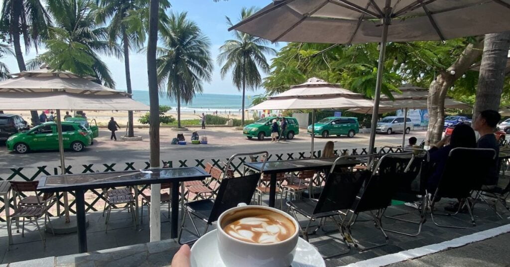 Tropical beach destination with palm trees and golden sunset over calm waters