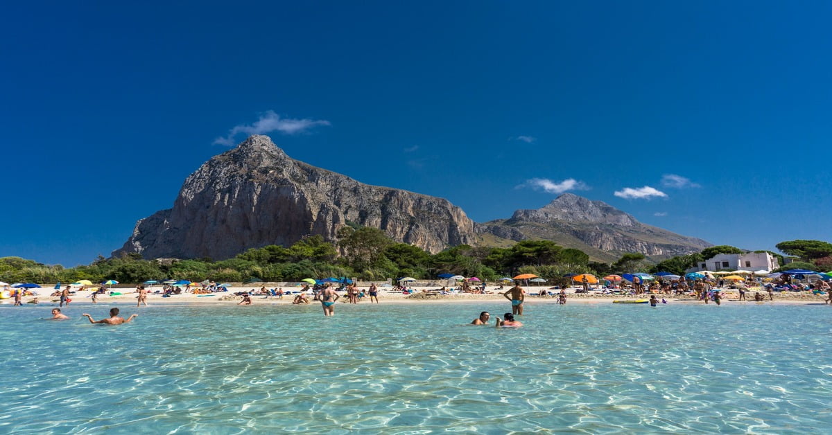 San Vito lo Capo beach with turquoise water and dramatic mountain backdrop in Sicily