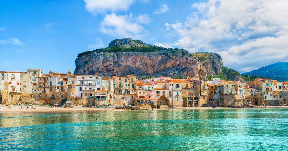 Cefalu beach with the medieval town and Norman cathedral in the background