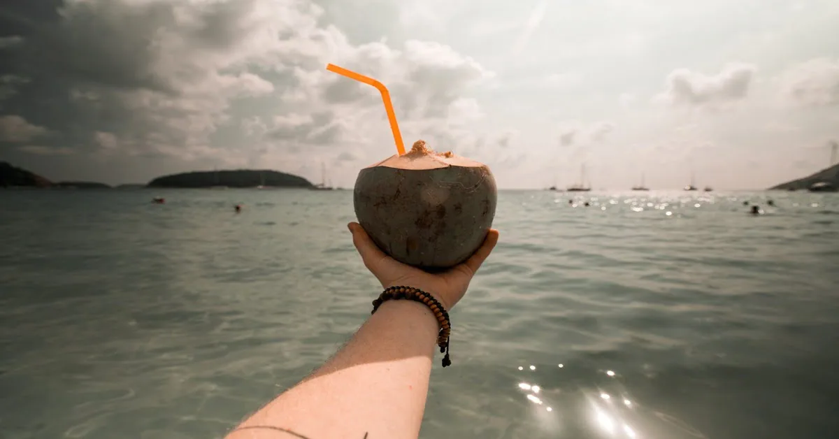 Phuket beach with crystal-clear water and lush tropical greenery