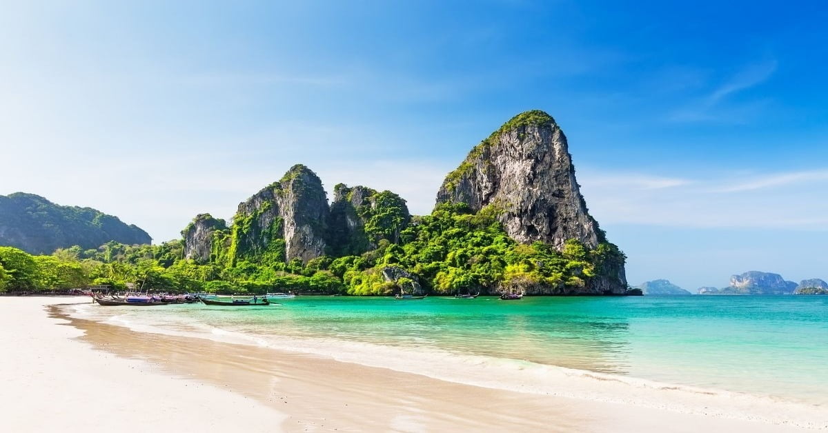 Scenic Krabi coastline with towering limestone cliffs and tropical vegetation