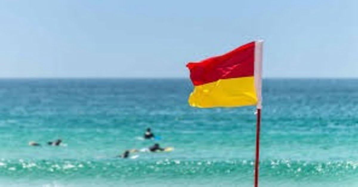 Beach safety sign and lifeguard equipment on a Thai beach
